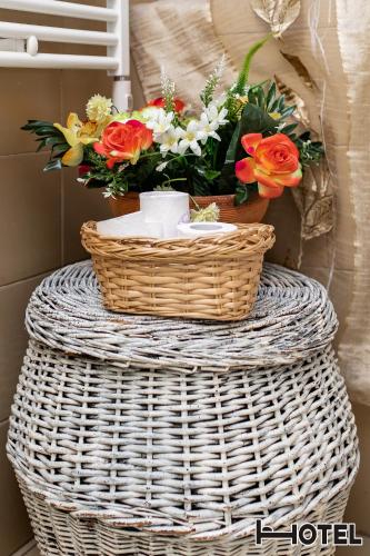 a basket with a bouquet of flowers on a table at Hotel Youri Il Magnifico in Genova