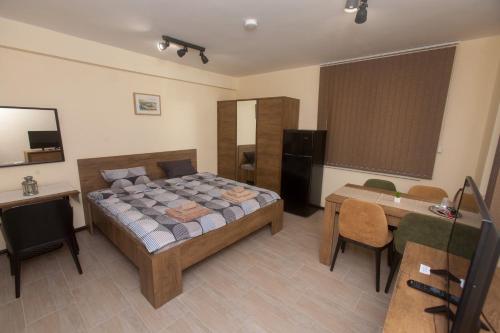 a bedroom with a bed and a desk and a table at Sofia Family House - Free Parking in Sofia
