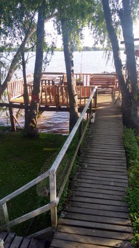 a wooden boardwalk leading to a bridge over the water at COEMBOTA Cabañas in Tigre