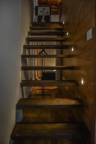a staircase in a room with wooden floors at Casa Romeo in Cuneo