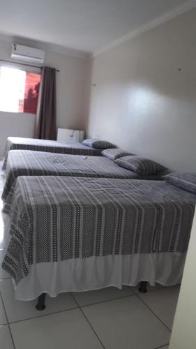 Una cama o camas en una habitación de Pousada Aerogrill