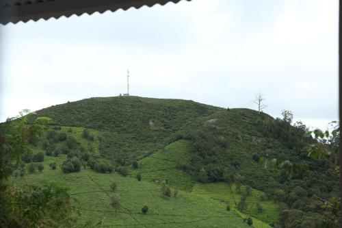 a hill with a cross on top of it at The Tamarillo in Ooty