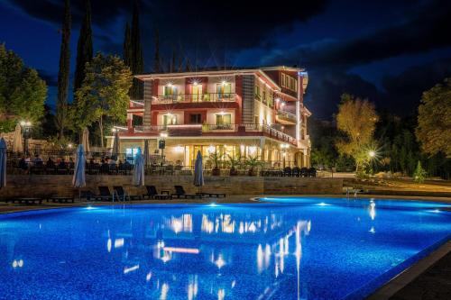 a hotel with a swimming pool at night at Villa Sintica in Sandanski