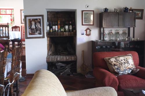 a living room with two chairs and a fireplace at Cabañas Yukatan Lago de Tota in Tota