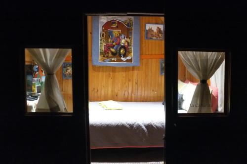 a bedroom with a bed and a mirror at Cabañas Yukatan Lago de Tota in Tota