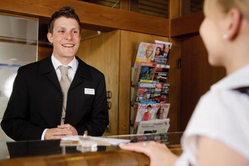a man in a suit sitting at a counter at Ringhotel Gasthof Hasen in Herrenberg