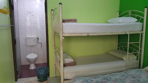 two bunk beds in a room with a toilet at ALORA BUDGET Inn in Tanah Rata