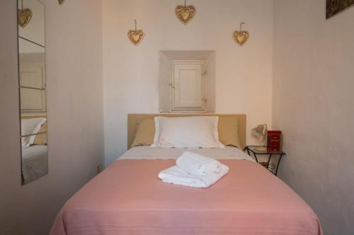 a bed with two towels on it in a room at Residenza d'Epoca " Il Campo" by FrancigenaApartments in Siena