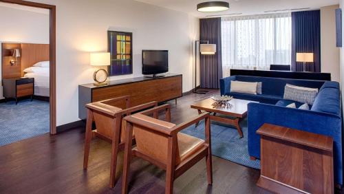 a living room with a blue couch and a tv at Hyatt Regency Minneapolis in Minneapolis