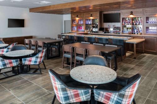a restaurant with tables and chairs and a bar at Hyatt Place Westminster Denver in Westminster