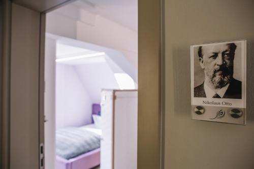 a picture of a man hanging on a wall at Boutique Hotel Pfauen in Schorndorf