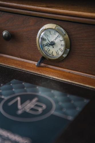 a clock is sitting on top of a table at Boutique Hotel Pfauen in Schorndorf