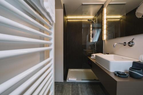 a bathroom with a sink and a mirror at Boutique Hotel Pfauen in Schorndorf