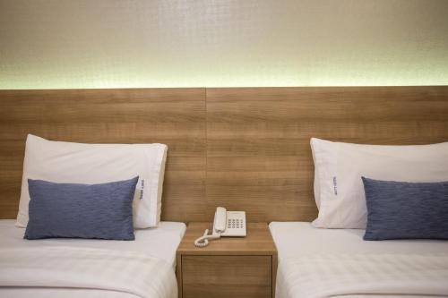 Postel nebo postele na pokoji v ubytování Unity Hotel