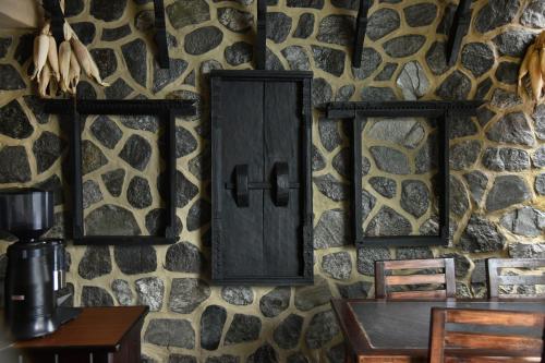 a stone wall with two mirrors and a table at Pokhara Boutique Hotel in Pokhara