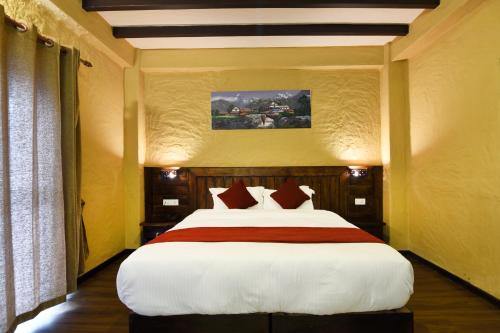 a bedroom with a large bed in a room at Pokhara Boutique Hotel in Pokhara