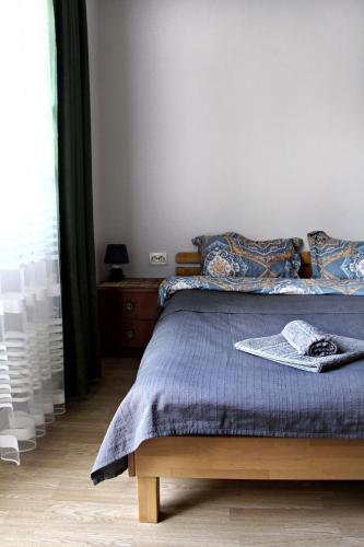a bedroom with a bed with a blue comforter at Apartments Astoria HN in Herceg-Novi