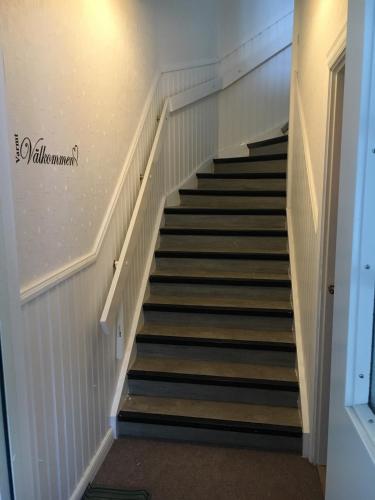 a stairway in a building with black and white stairs at Nebulosavägen 20 in Sundsbruk