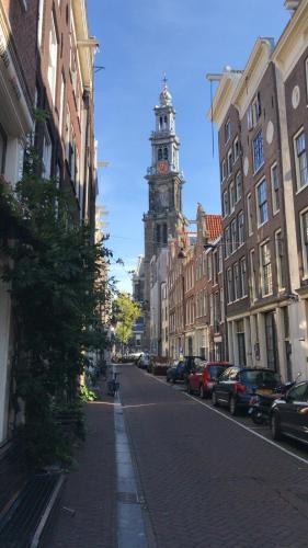 a city street with a clock tower in the distance at The Blossom House Amsterdam in Amsterdam