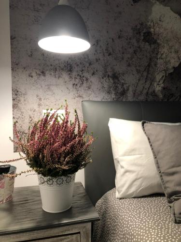 a potted plant sitting on a table next to a bed at Antinori Vatican Suite in Rome