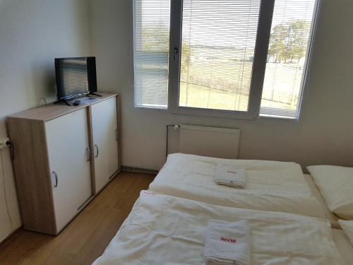 a room with two beds and a television in it at Country House Reem in Pommeuse