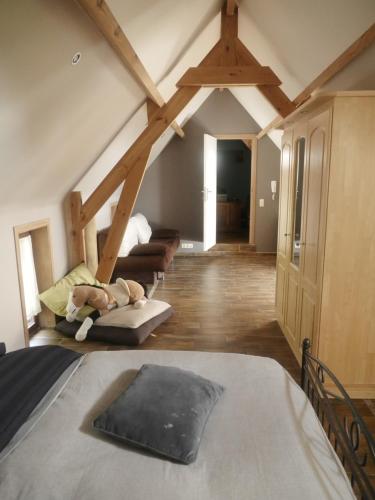 a bedroom with a bed and a room with beams at Gite 3 épis Tour de Charme in Péruwelz