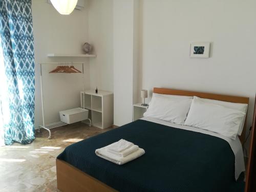 a bedroom with a bed with two towels on it at B&B La Terrazza Near The Beach in Bari