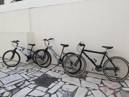 three bikes are parked next to a wall at Villa Mucifal D in Sintra