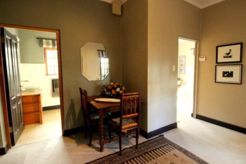 a dining room with a table and two chairs at The Bergzicht Guest Suite in Cape Town