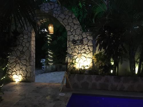 a building with a stone wall with lights on it at Hotel Casa San Juan in Valladolid