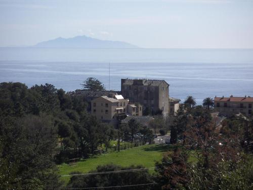 a group of buildings on a hill next to the ocean at Casa Luciani in Erbalunga