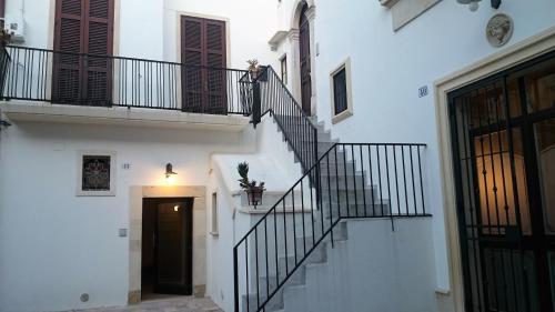 a staircase in a white building with a door at Sweet Home Arco Porta Luce in Galatina