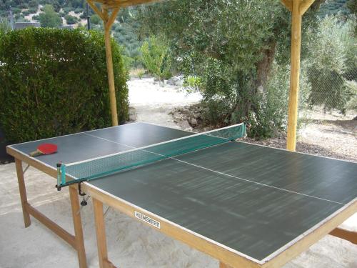 a ping pong table sitting in the sand with a table at B&B Lasnavillasmm in Montefrío