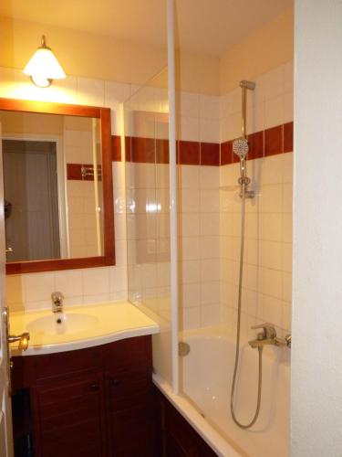 a bathroom with a shower and a sink and a tub at N23, parc d'arradoy-St J P de Port in Uhart-Cize