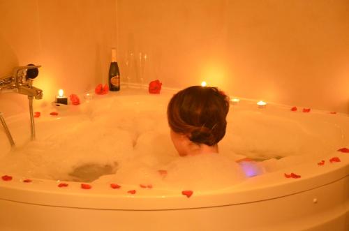 a woman is in a bath tub with candles at Francalancia Country Resort in Castelnuovo di Porto