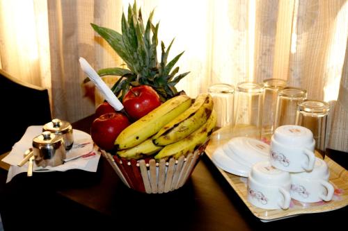 a basket of bananas and apples on a table at Hotel Nepalaya in Kathmandu