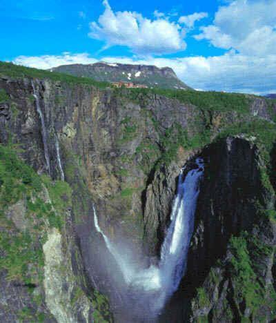a large waterfall in the middle of a mountain at Fossli Hotel in Eidfjord