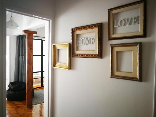 a group of framed pictures on a wall at Golden Apartment City Center in Lisbon
