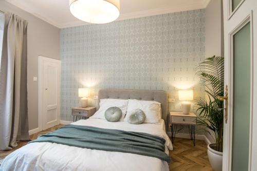 a bedroom with a bed with two pillows on it at Apartment Nearto Old Town Kraszewskiego street in Krakow