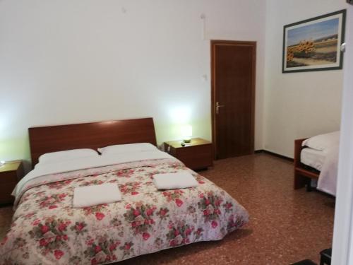 a bedroom with a bed with two towels on it at Venice Best Vacation in Marghera