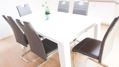 a white table and chairs with a plant on it at Ferienwohnung-Fuchs in Bad Schonborn