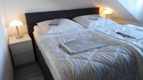 a large bed in a room with two pillows on it at Direkt Wolfsburg in Wolfsburg