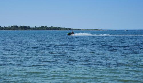 a boat in the middle of a large body of water at Emi House in Vourvourou