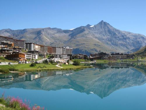 a view of a city with a reflection in the water at Le Paquis in Tignes