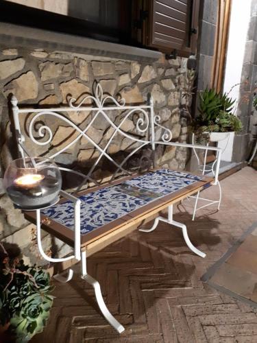 a bench sitting in front of a stone wall at Hill Valley View in Vico Equense