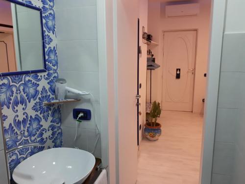 a bathroom with a toilet and a mirror on a wall at Hill Valley View in Vico Equense