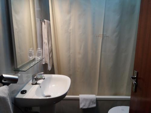 a bathroom with a sink and a shower curtain at Horizonte do Geres in Geres