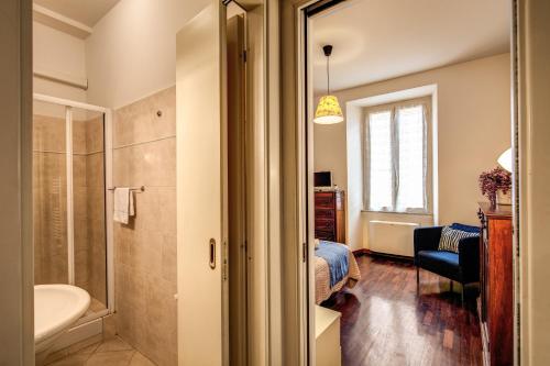 a bathroom with a shower and a sink and a bed at Boschetto in Rome