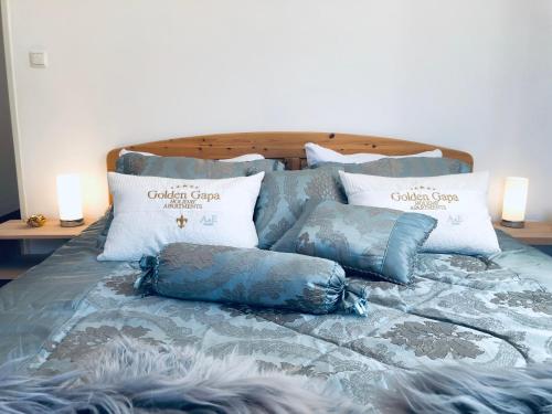 a bed with pillows on top of it at Golden GaPa Central Family Apartment 27 in Garmisch-Partenkirchen