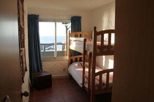 a bedroom with bunk beds with a view of the ocean at Suite Duplex special Amarras Reales in Piriápolis